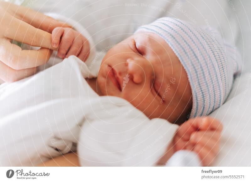 Portrait of a one day old newborn in the hospital baby portrait sleeping copy space parenthood motherhood innocence life labor young boy happy small pregnancy