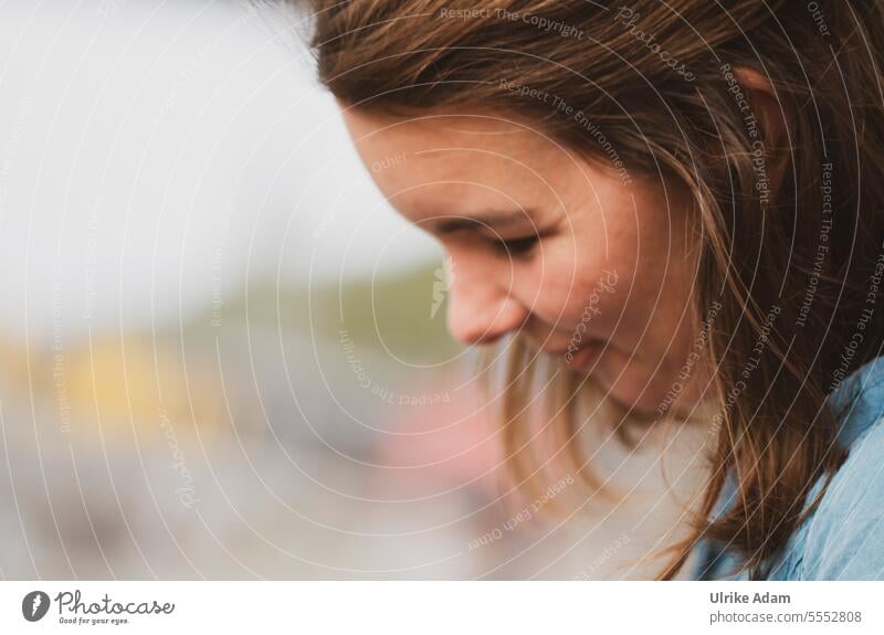 Wide land | smirk - woman looks down and smiles Attractive Facial expression Congenial pretty Self-confident Emanation Friendliness Sympathy Happy Happiness