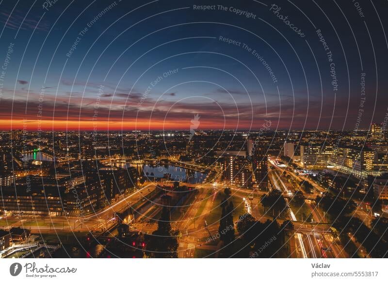 Aerial view of nightlife in the modern city of Rotterdam in the Netherlands. Red glow from the setting sun in the background rotterdam downtown twilight dutch