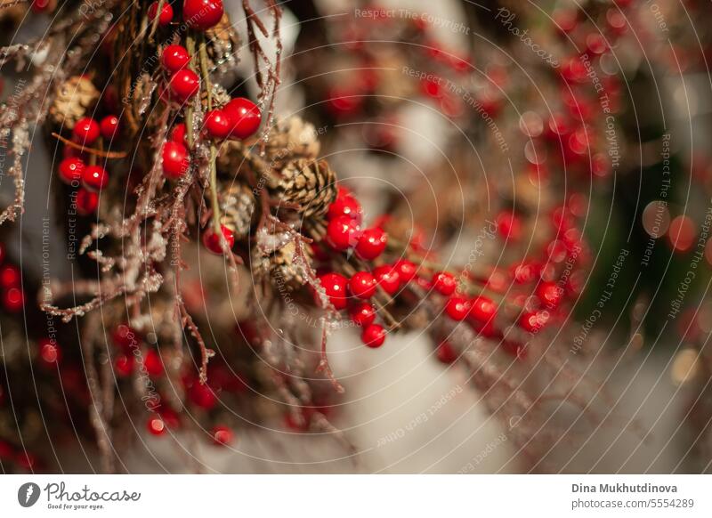 eco wooden Christmas wreath with red berries closeup background. Holiday season home decoration. xmas christmas wreath green winter celebration festive diy