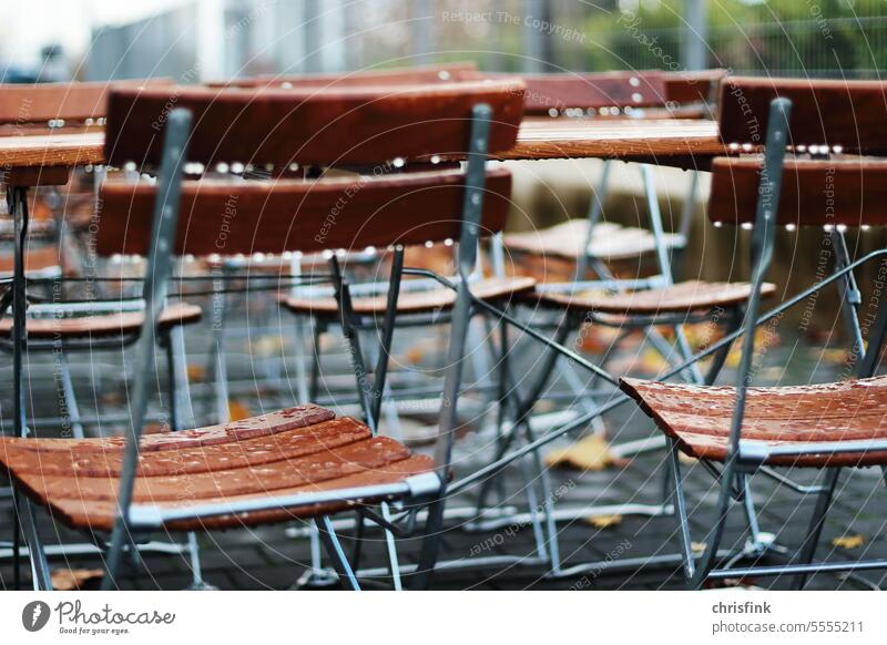 Folding chairs in the rain at table Chair Rain Table Café Restaurant Roadhouse Autumn Winter Gastronomy Beer garden Seating Sidewalk café Terrace Closed