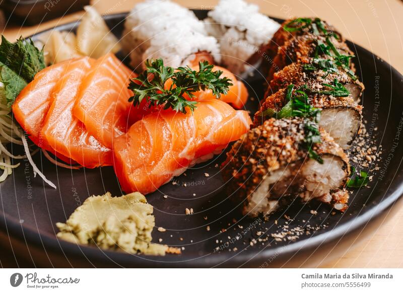 black plate with pieces of sushi background dish traditional meal dinner rice asian restaurant reflection avocado seafood philadelphia shot cheese roll gourmet