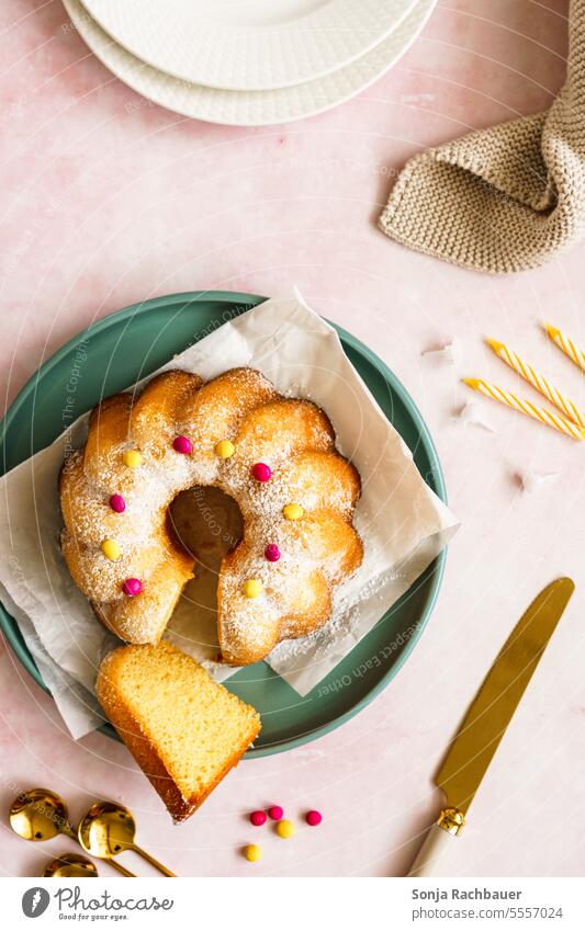 A Gugelhupf on a green plate. View from above. Plate Cake slice Colour photo cute Delicious To have a coffee Dessert Food Interior shot Nutrition Knives Spoon