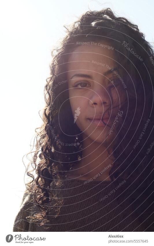 Backlight portrait of beautiful young woman with curly hair Woman Young woman Curly pretty Slim attractive good-looking emotion Model Esthetic Adults