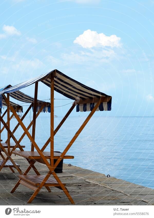 empty market stalls by the sea Blue Sky Summer Ocean Stripe off-season Empty wharf Markets market stands Market stall sales booth Sales booths Exterior shot