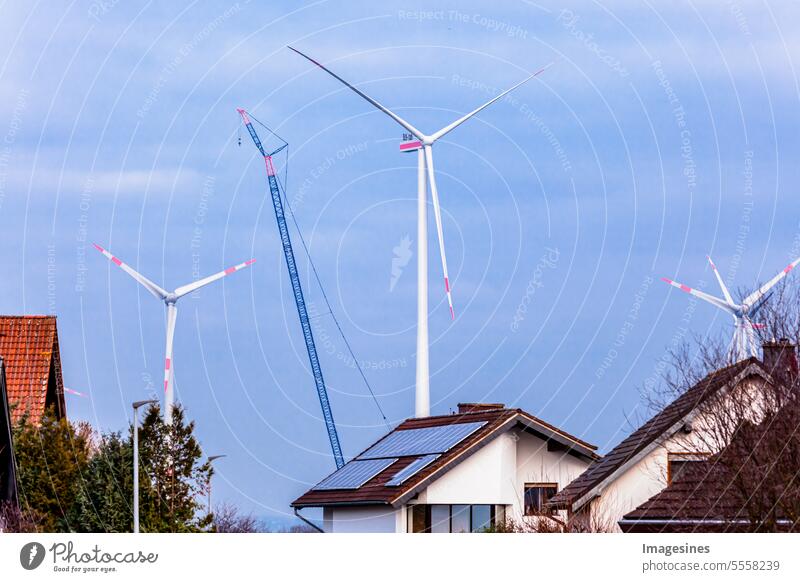 Construction and assembly of a wind turbine by crane near a residential area. Construction work on the wind farm in Wörrstadt, Germany. Energy-saving concept from wind turbine construction