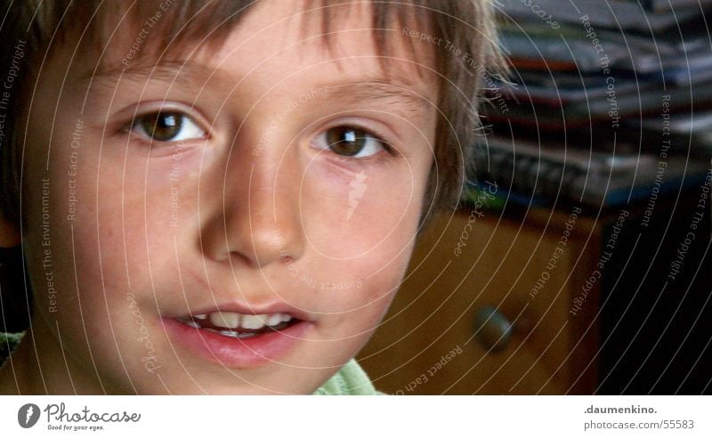 head cinema Boy (child) Child Lips Wood Paper Hesitate Fascinating Human being Eyes Mouth Hair and hairstyles strin Nose Face Magazine Desk Looking Laughter