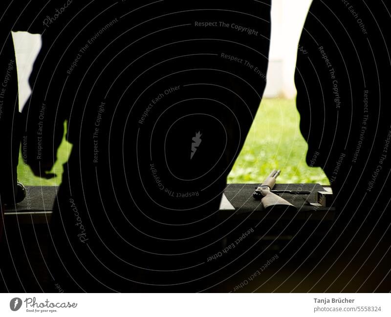 Laid down rifle (bolt action) between shooters shadow Repeating rifle Rifle shooting Firearm Weapon Shoot at the shooting range society for the protection