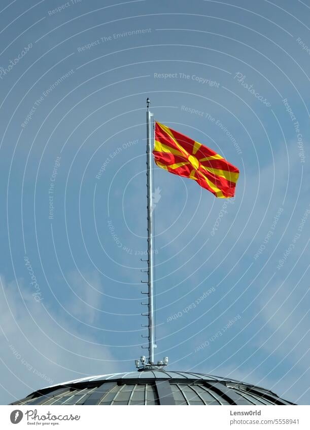 The national flag of North Macedonia waving in the wind in Skopje balkan balkans banner copy space country emblem flagpole government identity independence