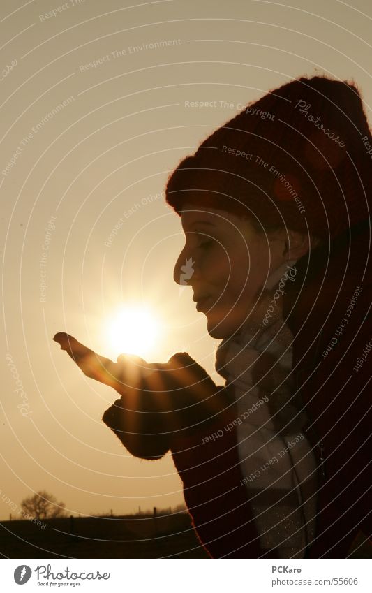 kiss of the sun Kissing Woman Cold Winter Evening sun Lighting Sunset Cap Field Brown Yellow Dark Scarf siluette Exterior shot