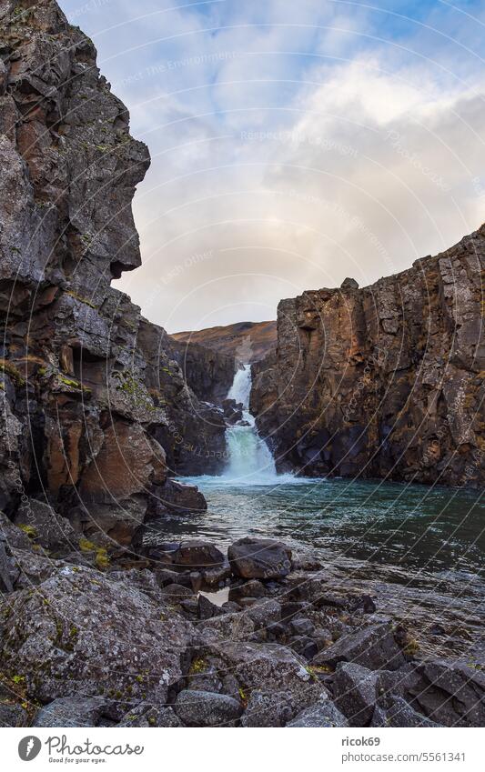 View of Tófufoss waterfall in the east of Iceland Waterfall River Island Landscape Nature mountain Rock Autumn Sky Clouds Blue Idyll vacation voyage destination