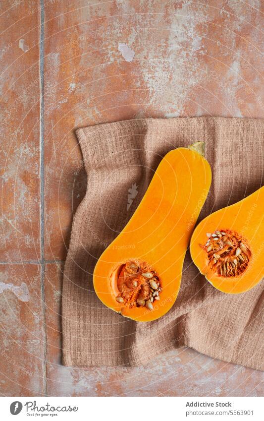 Cut half of vivid ripe pumpkin orange seeds flesh cut harvest vegetable health food natural cuisine nutrition season organic vitamin plant cooking autumn