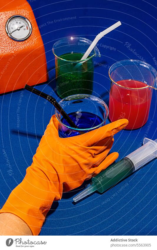 Chemical drinks on blue table near machine and syringe processed chemical laboratory cocktail chemically glass still life creative conceptual artistic color