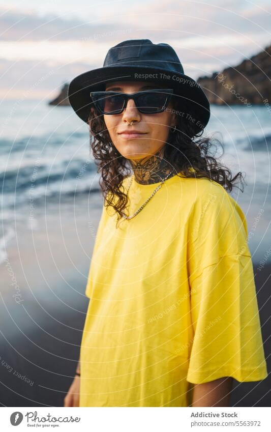 Pensive woman with hands in pockets on beach portrait sea pensive seashore ocean thoughtful calm coast female sand wave nature sunglasses wind water Tenerife