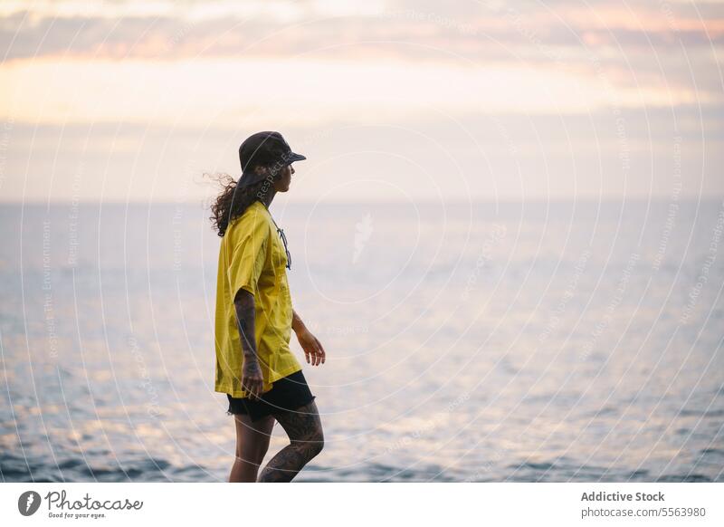 Pensive woman walking beach sea pensive seashore ocean thoughtful calm coast female sand wave nature wind water Tenerife Canary Islands seaside rest tattoo