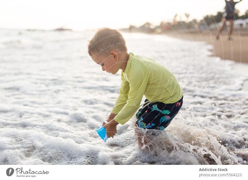 Child playing on sandy beach in summer day child toy shore waves sunny kid preschool childhood little coast nature travel seafront boy trip weekend adventure