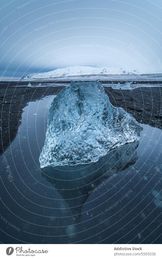 Broken ice on black beach in sea water in Iceland iceland diamond beach black sand highland landscape coast wave ocean ripple cloudy sky winter glacier