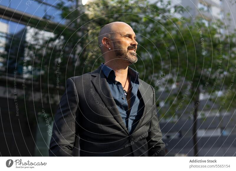 Portrait of a bearded and bald business man on the street person businessman portrait looking male adult city entrepreneur face outdoors horizontal one person