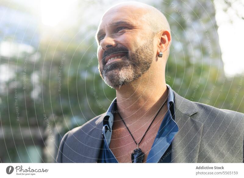 Portrait of a bearded and bald business man on the street person businessman portrait looking male adult city entrepreneur face outdoors horizontal one person