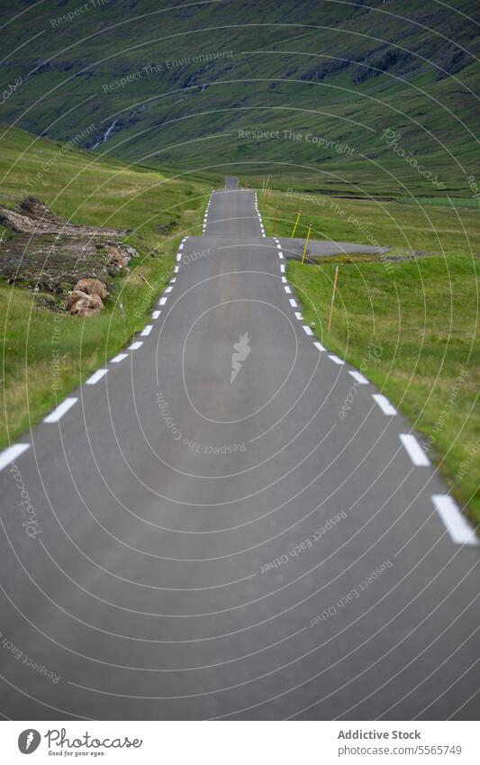 Empty asphalt road leading to mountain empty roadway valley countryside travel route trip faroe islands road trip nature green landscape hill ridge range