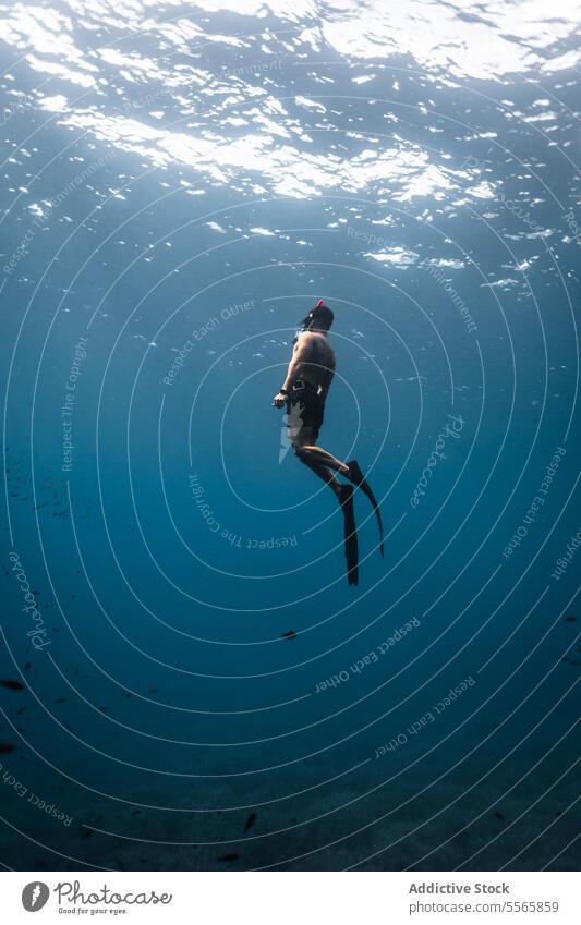 A man swimming in the ocean with a mask on snorkel underwater Menorca Mediterranean Sea beach clear water marine life fish diving snorkeling adventure