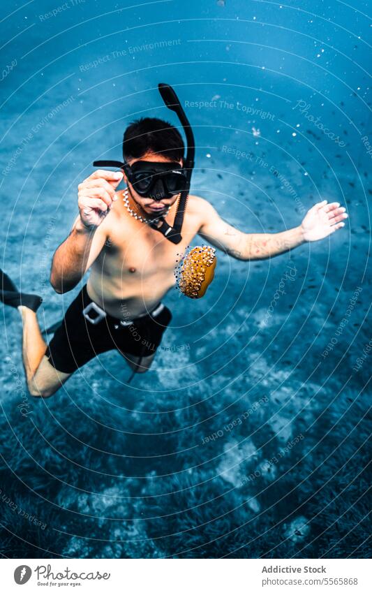 A man swimming in the ocean with a mask on snorkel underwater Menorca Mediterranean Sea beach clear water marine life fish diving snorkeling adventure