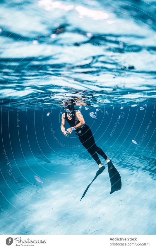 A man swimming in the ocean with a mask on snorkel underwater Menorca Mediterranean Sea beach clear water marine life fish diving snorkeling adventure