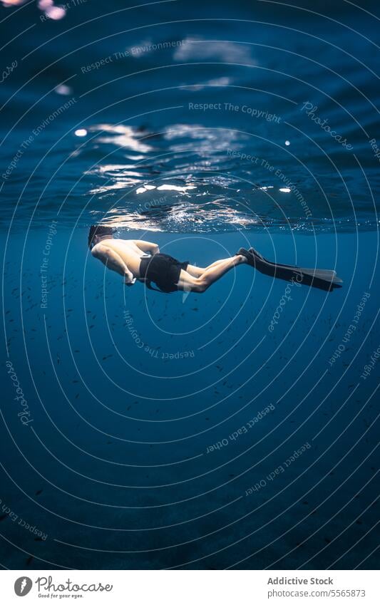 A man swimming in the ocean with a mask on snorkel underwater Menorca Mediterranean Sea beach clear water marine life fish diving snorkeling adventure