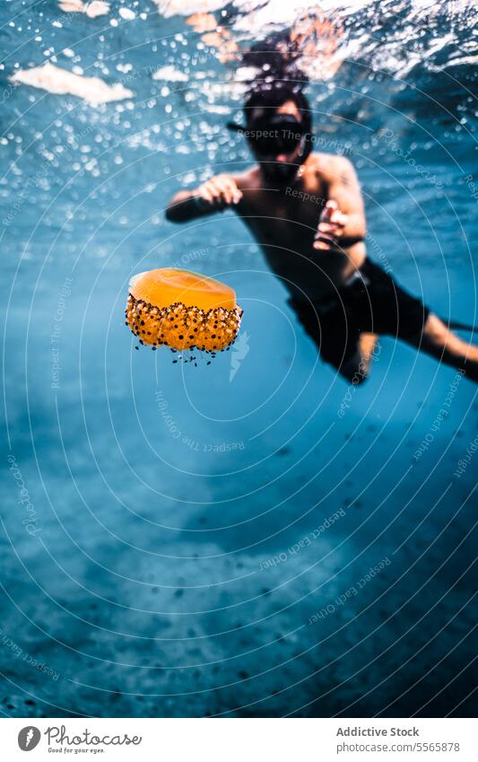 A man swimming in the ocean with a mask on snorkel underwater Menorca Mediterranean Sea beach clear water marine life fish diving snorkeling adventure