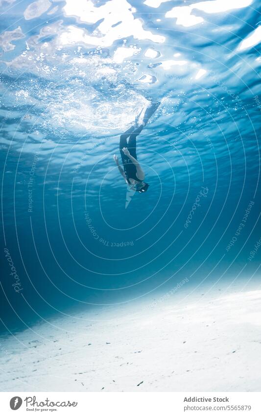 A man swimming in the ocean with a mask on snorkel underwater Menorca Mediterranean Sea beach clear water marine life fish diving snorkeling adventure