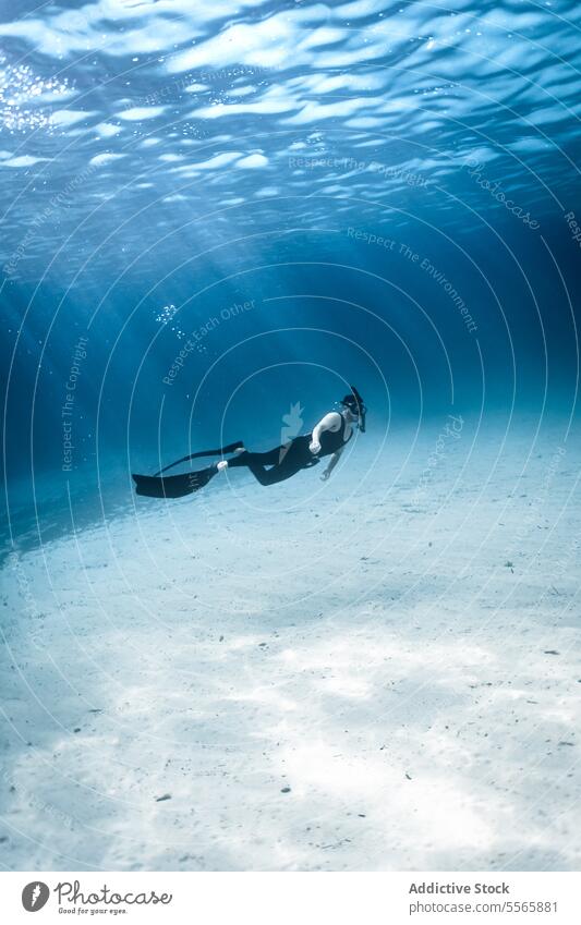 A man swimming in the ocean with a mask on snorkel underwater Menorca Mediterranean Sea beach clear water marine life fish diving snorkeling adventure