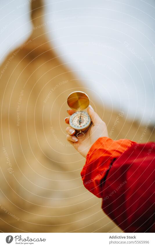 A person holding a compass in their hand desert navigation traveler landscape adventure bardenas reales navarra exploration direction map outdoor wilderness