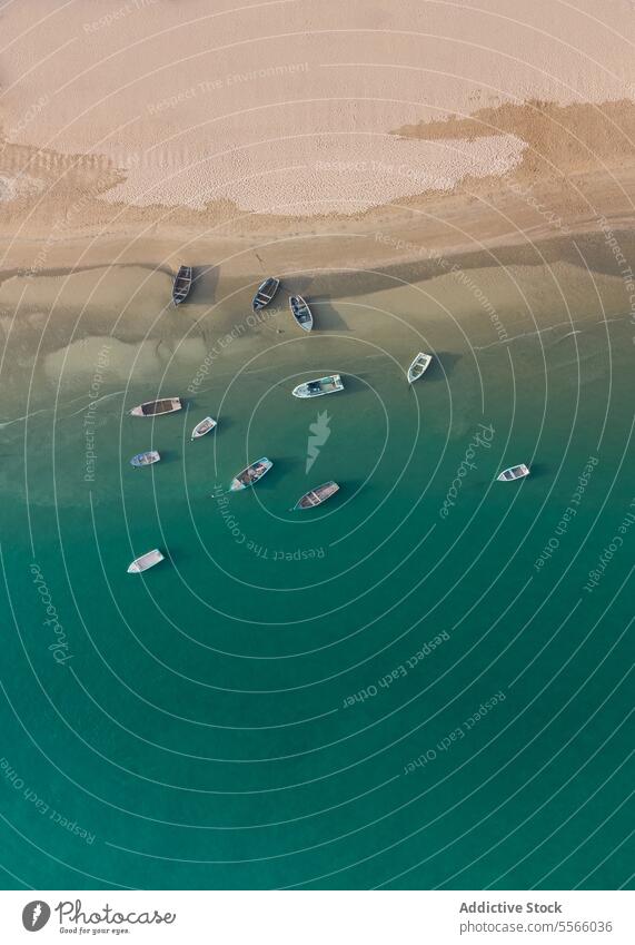 Boats floating in sea near shore boat fishing boat various ocean marine nautical beach sand el rompido huelva spain europe turquoise sailboat moor many vessel