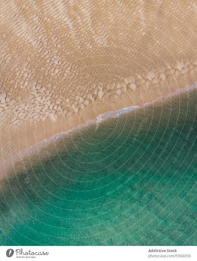 Sandy shore of turquoise sea in summertime ocean beach rough ripple sand shoreline coast resort el rompido huelva spain europe island scenic seawater exotic