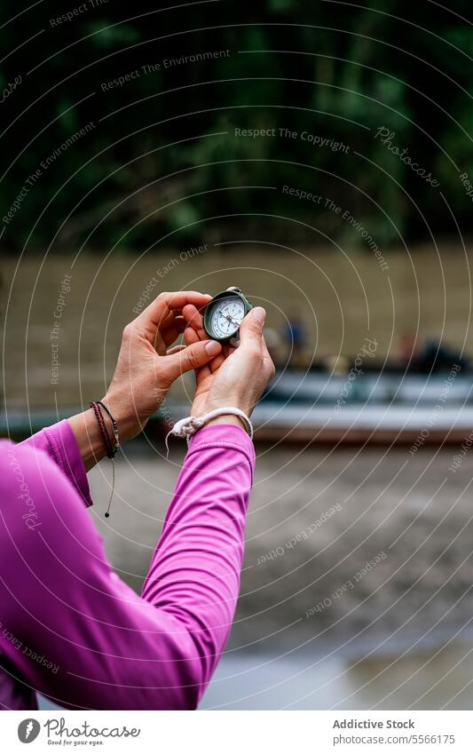 Crop unrecognizable woman with vintage clock travel compass people holding hands nature direction adventure orientate retro traveler journey explore trip