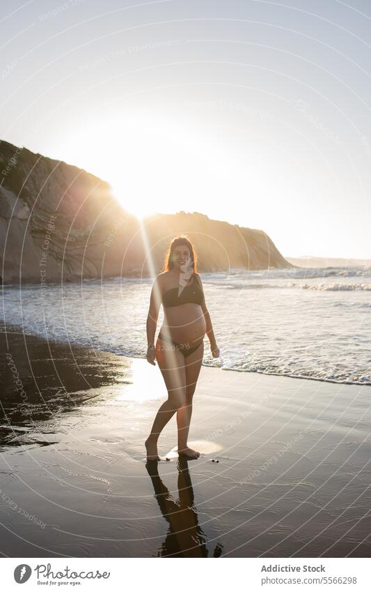 Pregnant woman walking near sea pregnancy coast shore pregnant tender mother parent expect barefoot anticipate maternal summer tummy stroll belly happy water