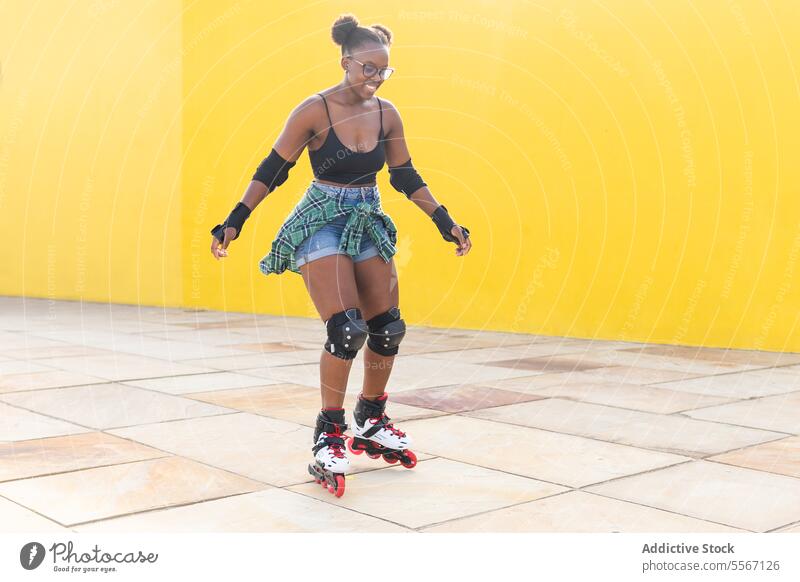 Happy Young Female Rollerskating At Skate Park Woman Skating Smile Casual Wall Yellow Sport Practice Leisure Weekend Activity Summer Lifestyle Training