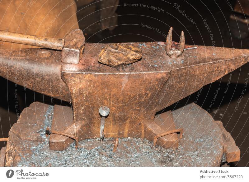 Detailed view of blacksmith anvil and tools hammer craft forge metal rust detail close-up work iron weathered traditional Europe unique hydraulic mallet