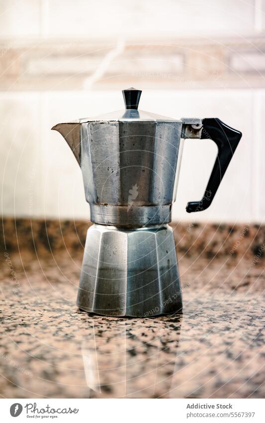 Vintage moka pot on granite coffee maker vintage silver aluminum countertop kitchen espresso brew handle metal Italian design classic stovetop beverage morning