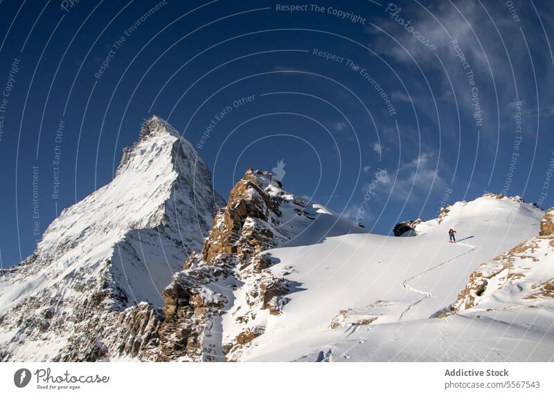 Person with ski equipment climbing snowcapped mountain person back view unrecognizable pole walking covering vacation adventure swiss alps hiking skier peak