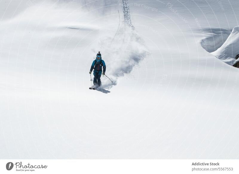 Person skiing on snowcapped mountain during vacation person unrecognizable equipment skier snowy hiking nature full body sunny winter pole lifestyle explorer