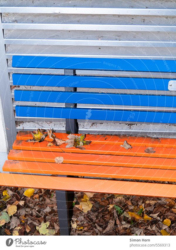 Two-tone park bench stands in front of ventilation slots Park bench Ventilation Sit foliage lines Pattern Structures and shapes Lines and shapes Abstract Stripe