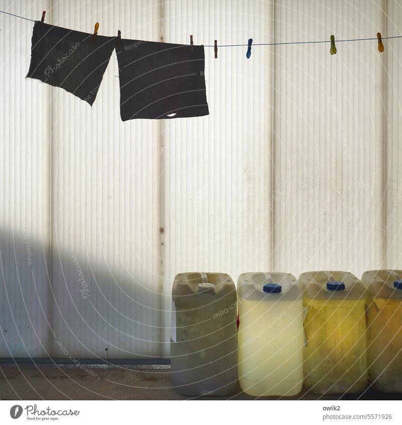 Lapland clothesline Floor cloth rag Rag Hang Dangle Dry Colour photo Long shot Exterior shot Deserted Calm Patient Wait Silhouette Contrast Sunlight Shadow