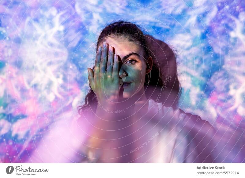 Woman in quest for inner clarity in a cosmic introspective stance woman introspection spiritual mental hand eye challenge balance universe aura emotion journey