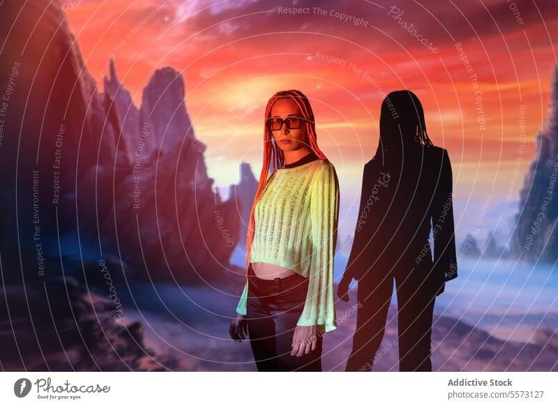 Serious woman with orange braids against mountain beautiful confident serious sunglasses afro braids radiant neon projector virtual portrait cool attitude glow