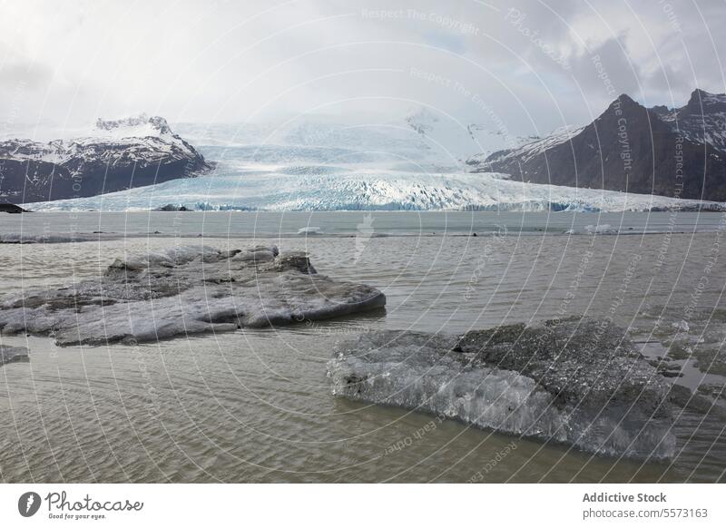 Glacier and frozen lake with snow mountains in background glacier iceland picturesque range weather rock sky nature climate cold white peaceful majestic