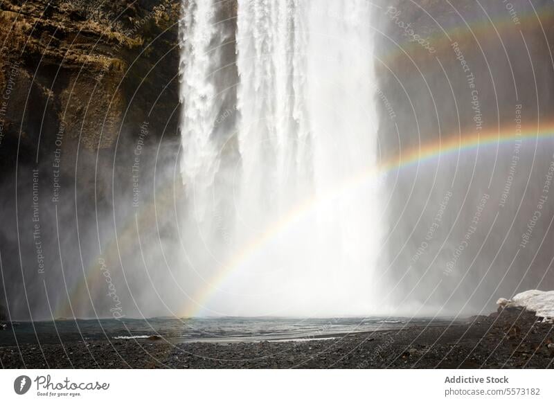 Rainbow near waterfall in nature rainbow cliff mountain power stream splash energy iceland refraction pure scenic highland flow cascade rock weather drop season