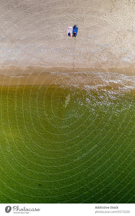 Drone shot of anonymous people at Sardinian beach Italy umbrella towel sand shore aerial li junchi summer vacation holiday sunbathing relaxation coast ocean sea