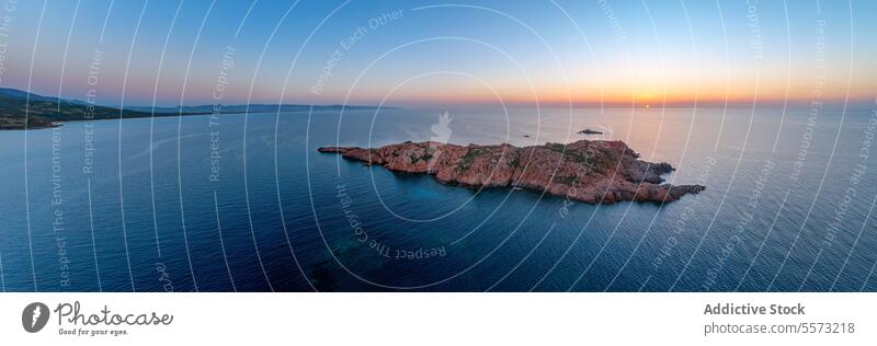 Rocky cliff islet located in blue ocean in Italy rocky ripple horizon cloudless sky sunset island nature isola rossa sardinia italy europe Castelsardo evening