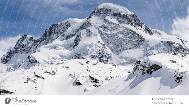 Idyllic mountain and landscape covered with snow against sky picturesque range rock covering peak top winter natural high alpine travel valley snowcapped ice